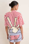 Model in a classic, effortless Navy Stripes Off-White Tie Front Blouse, featuring playful sun motif and fun, high-end striped pattern, embodying relaxed, confident style.