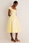 Woman in Yellow Adilene Midi Dress, featuring a classic fit-and-flare silhouette with puffed sleeves and side pockets, embodying an effortless, high-end style.
