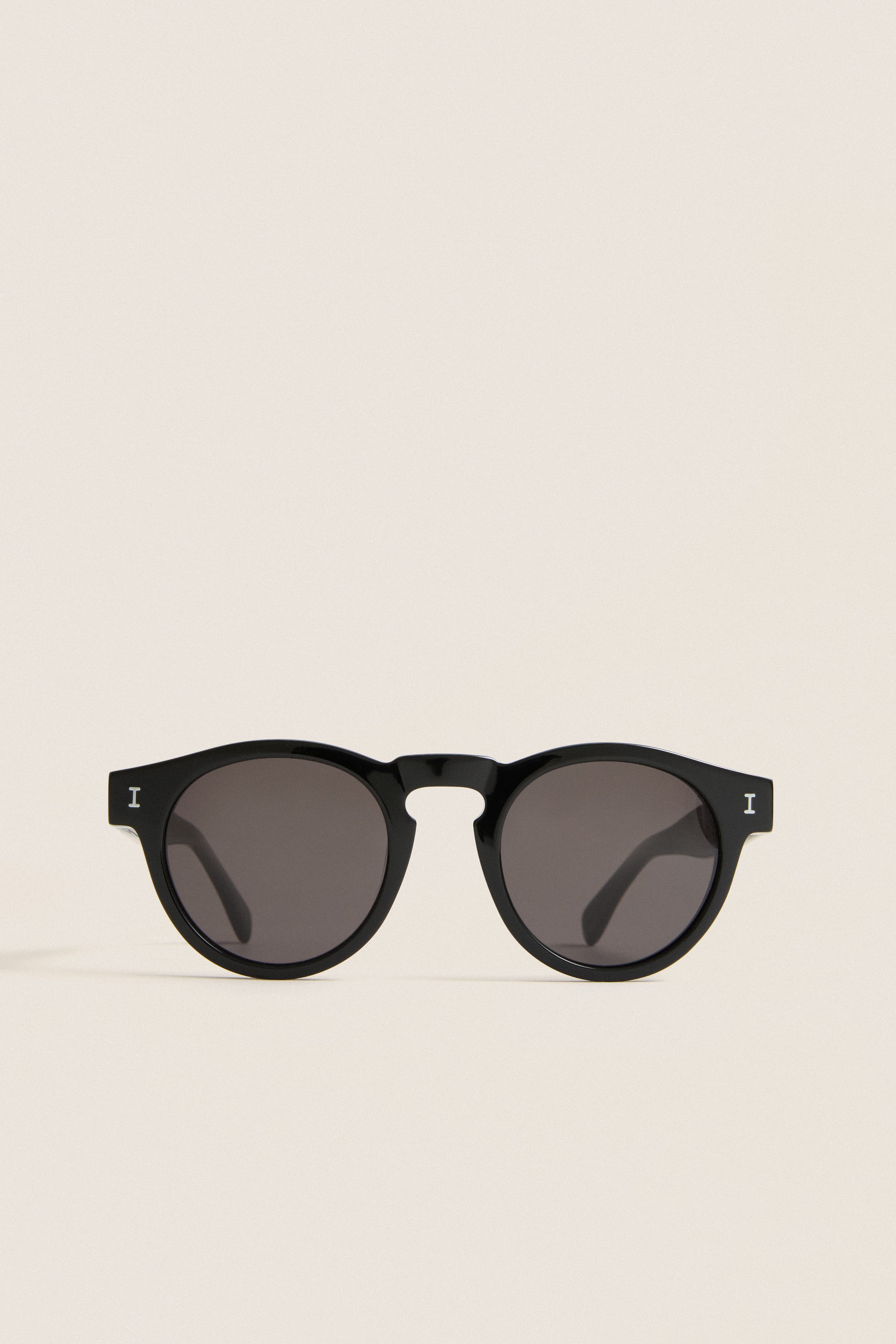 Classic Black Leonard Sunglasses with round lenses and a sleek key-hole bridge, embodying effortless style and fun luxury, perfect for high-end everyday wear.