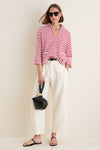 Model wearing Black Leonard Sunglasses with a classic round silhouette, effortlessly styled with chic accessories, embodying a fun and high-end look for everyday adventures.