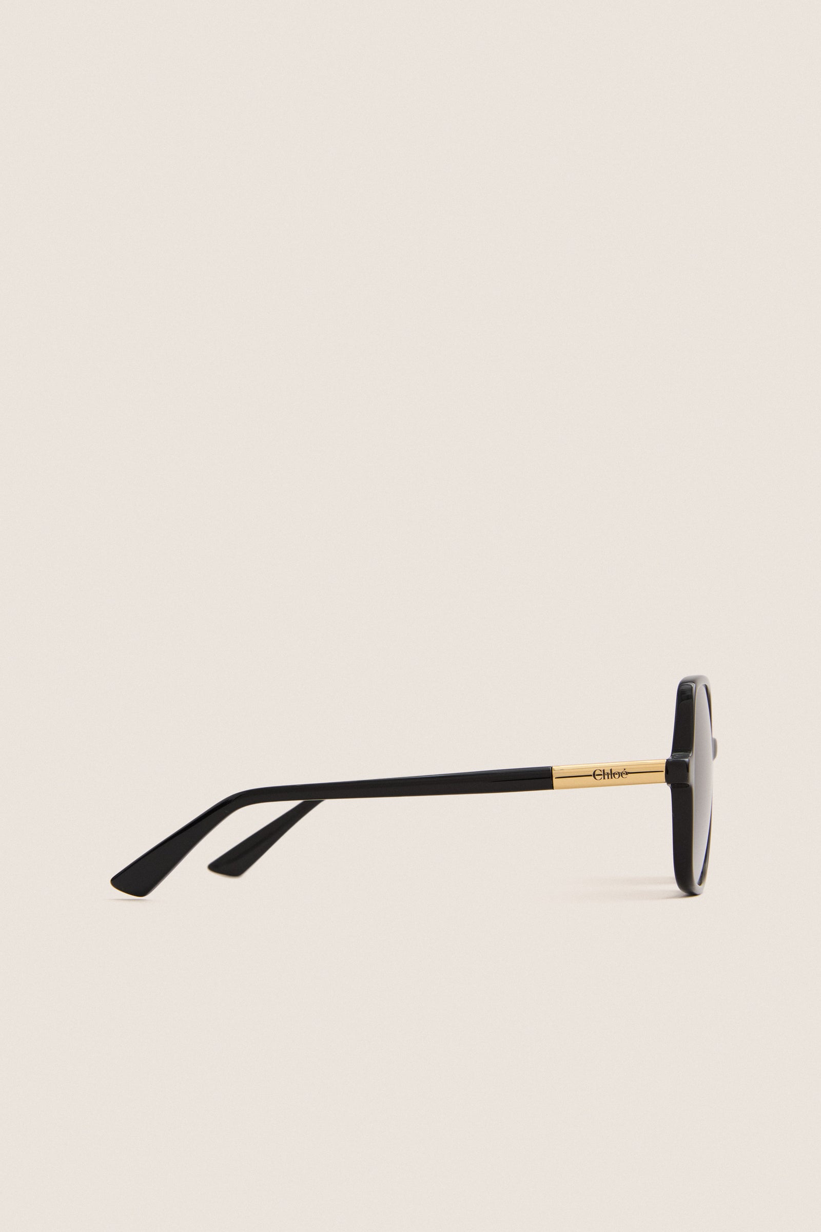 Shiny Black Judy Sunglasses feature classic black frames with a gold metal accent and etched Chloé logo, offering an effortless, high-end style for fun, confident wear.