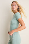 Eucalyptus Slim Fit Pointelle Tee in mint-green, worn by a woman in profile. Features classic pinhole stripes, scalloped edges; effortlessly chic loungewear for versatile, high-end styling.