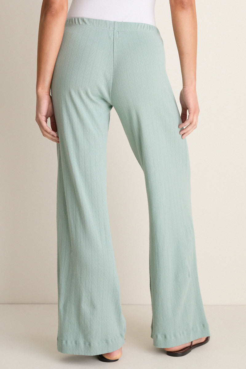 Model wearing Eucalyptus Pointelle Boxer Pants, showcasing their classic, effortless wide-leg design and elastic waistband in a high-end, fun studio setting.