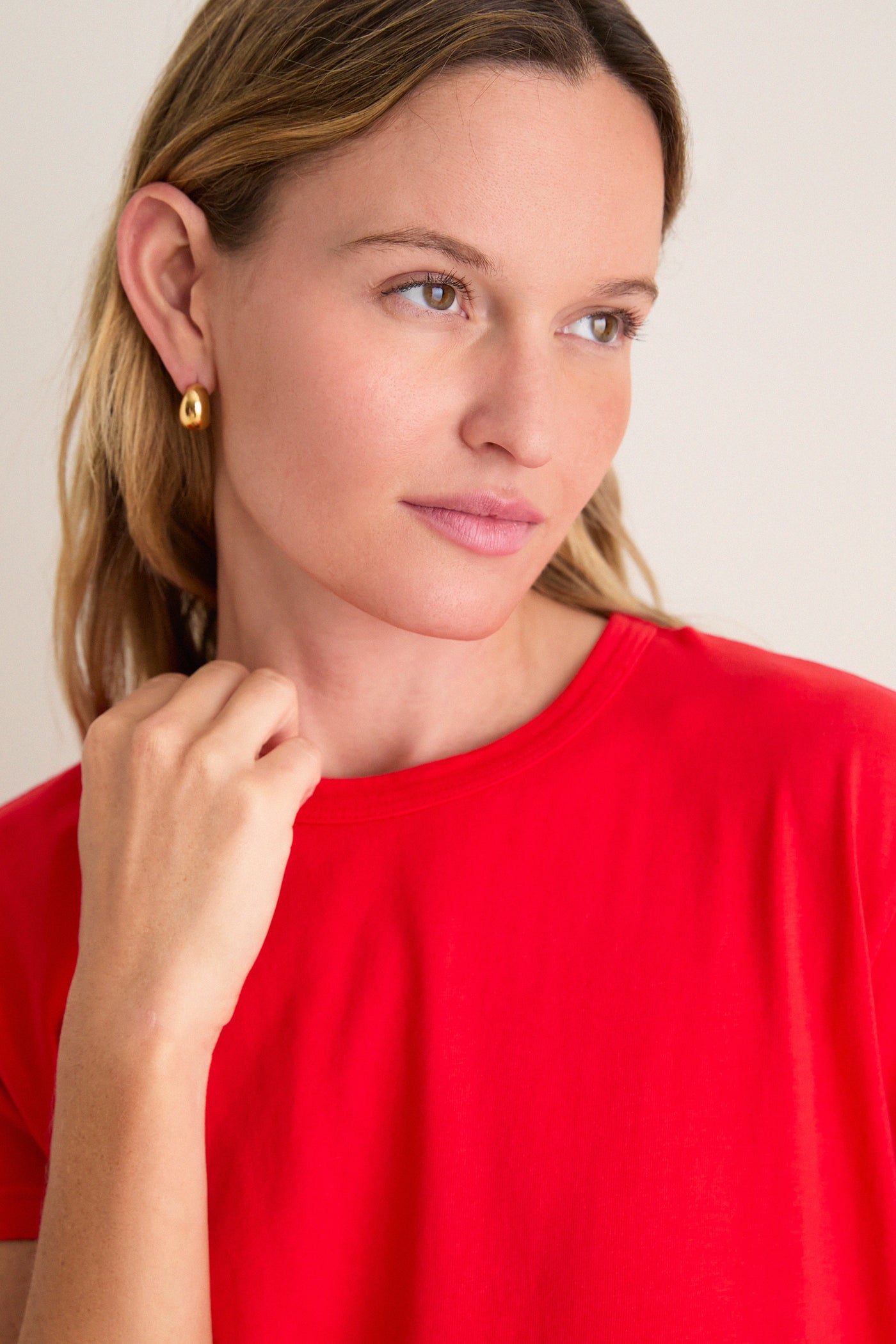 Young woman in a bright red Cerise Margo Mini Dress with a boxy silhouette and crew neckline, embodying classic and effortless high-end style.