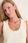 Young woman models the classic Ivory Cotton Rope Mariner Tank featuring a scalloped neckline, paired with a gold hoop earring, embodying effortless, high-end style.