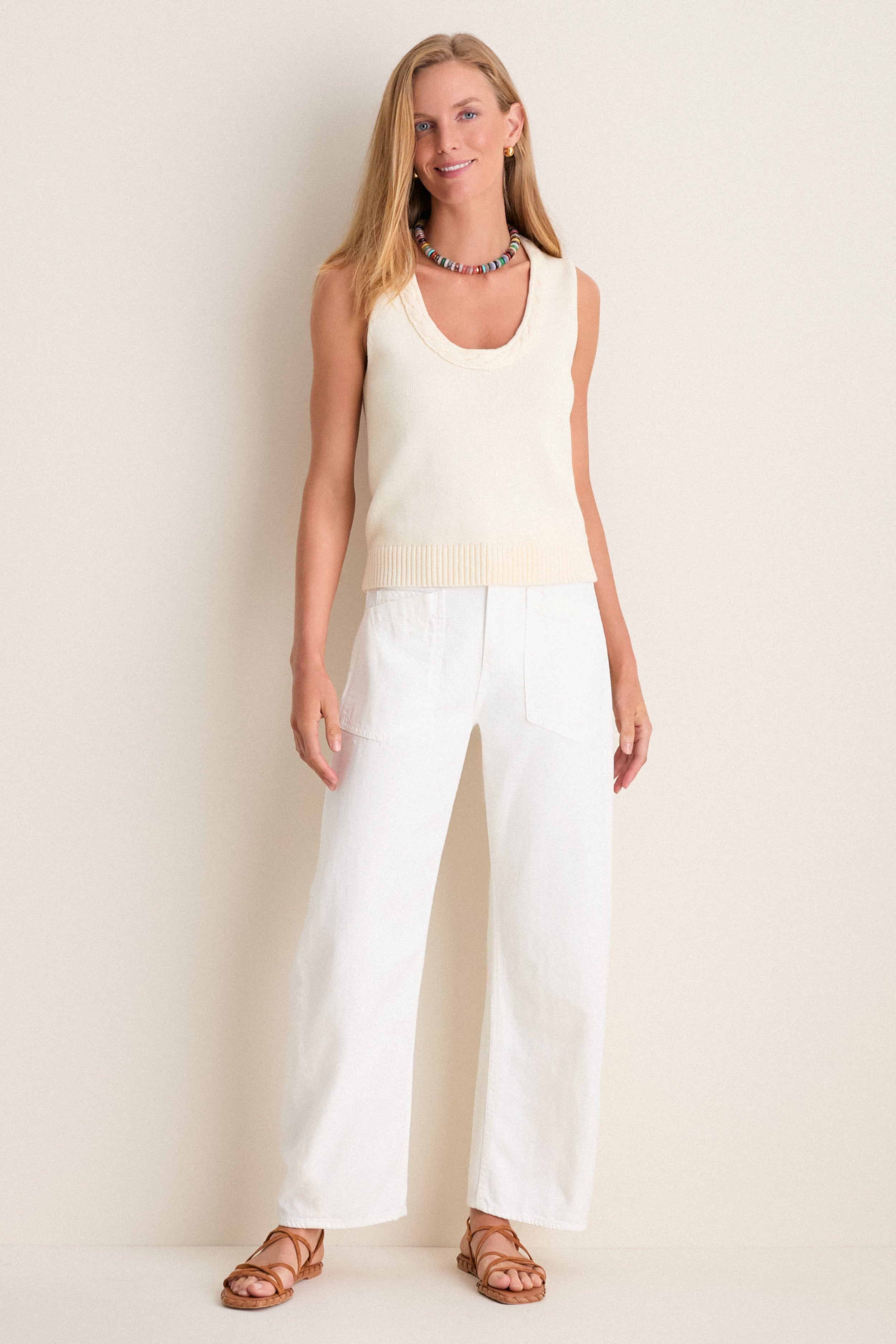 Model wearing the classic Ivory Cotton Rope Mariner Tank, paired with high-waisted pants and sandals, exuding an effortless, fun, and high-end style.