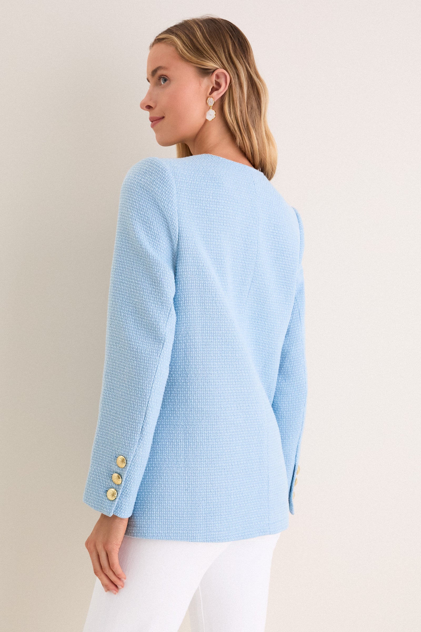 Light Blue Tweed Jennings Jacket on woman, showcasing classic, high-end style with gold buttons and flap pockets. Effortlessly fun and professional ensemble with drop earrings.