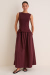 Woman in Dark Cherry Boatneck Mix Media Midi Dress with side pockets, styled effortlessly with black sandals for a classic, high-end look, perfect for fun day-to-night transitions.