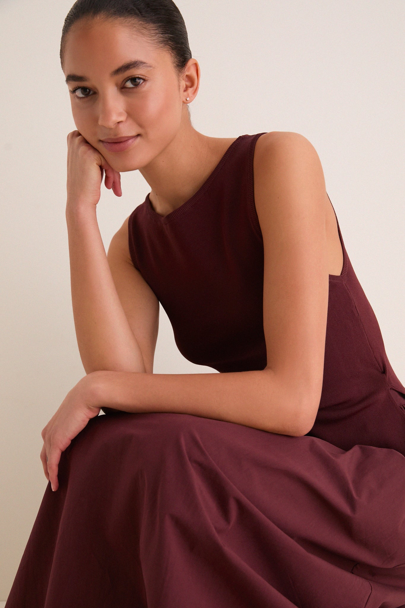 Young woman wearing the Dark Cherry Boatneck Mix Media Midi Dress, showcasing its classic, effortless style with a sleek silhouette and elegant neckline, perfect for day-to-night transitions.