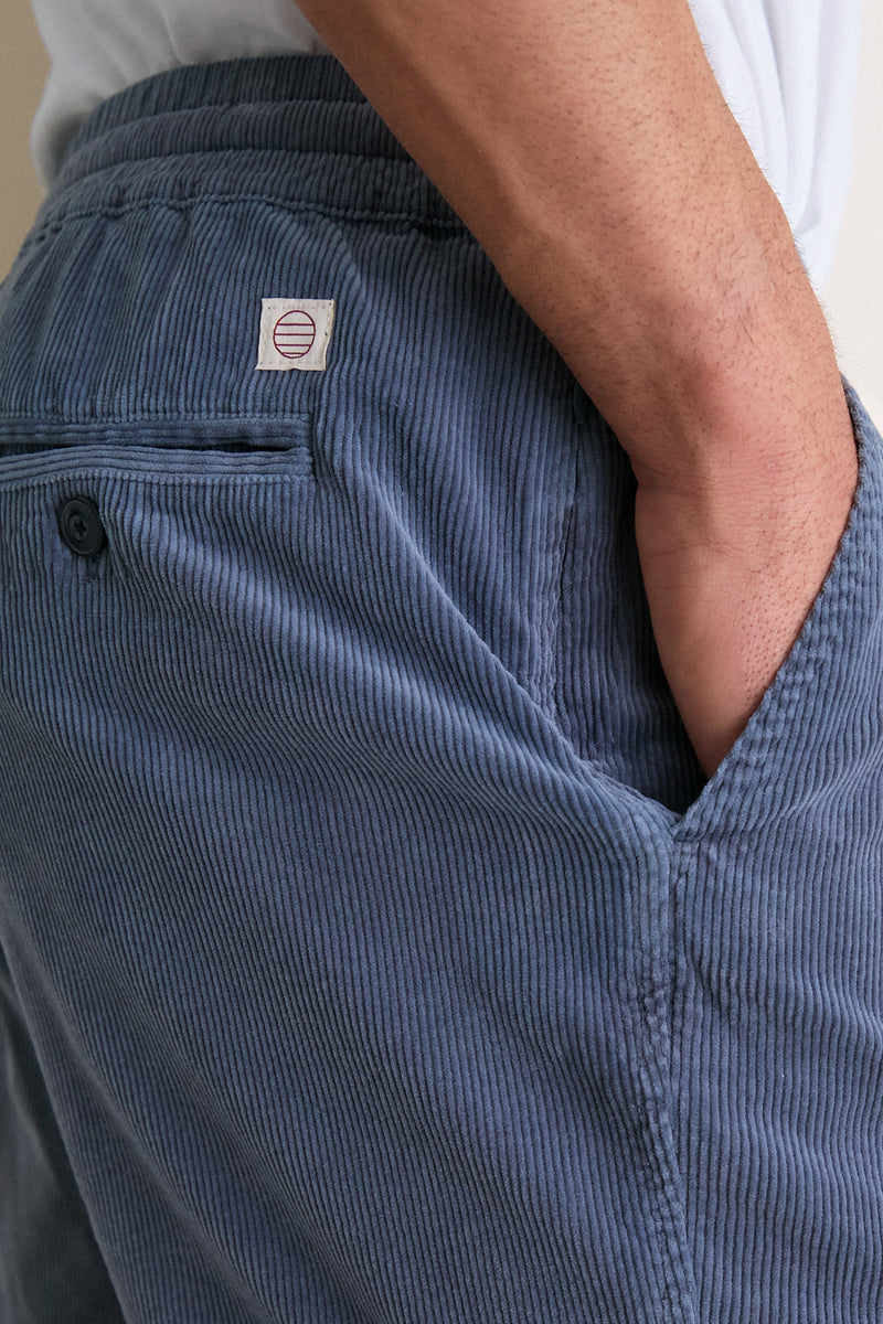 Faded Navy Saturday Corduroy Short with an elastic waistband, side and back pockets, and a hidden zipper stash pocket. Classic and effortlessly cool, perfect for summer adventures.