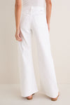 Back view of Pinch of Salt The Lemon Twist Skimp, featuring high-waisted, wide-leg white pants with rear pockets, embodying a classic, effortless style with high-end appeal.