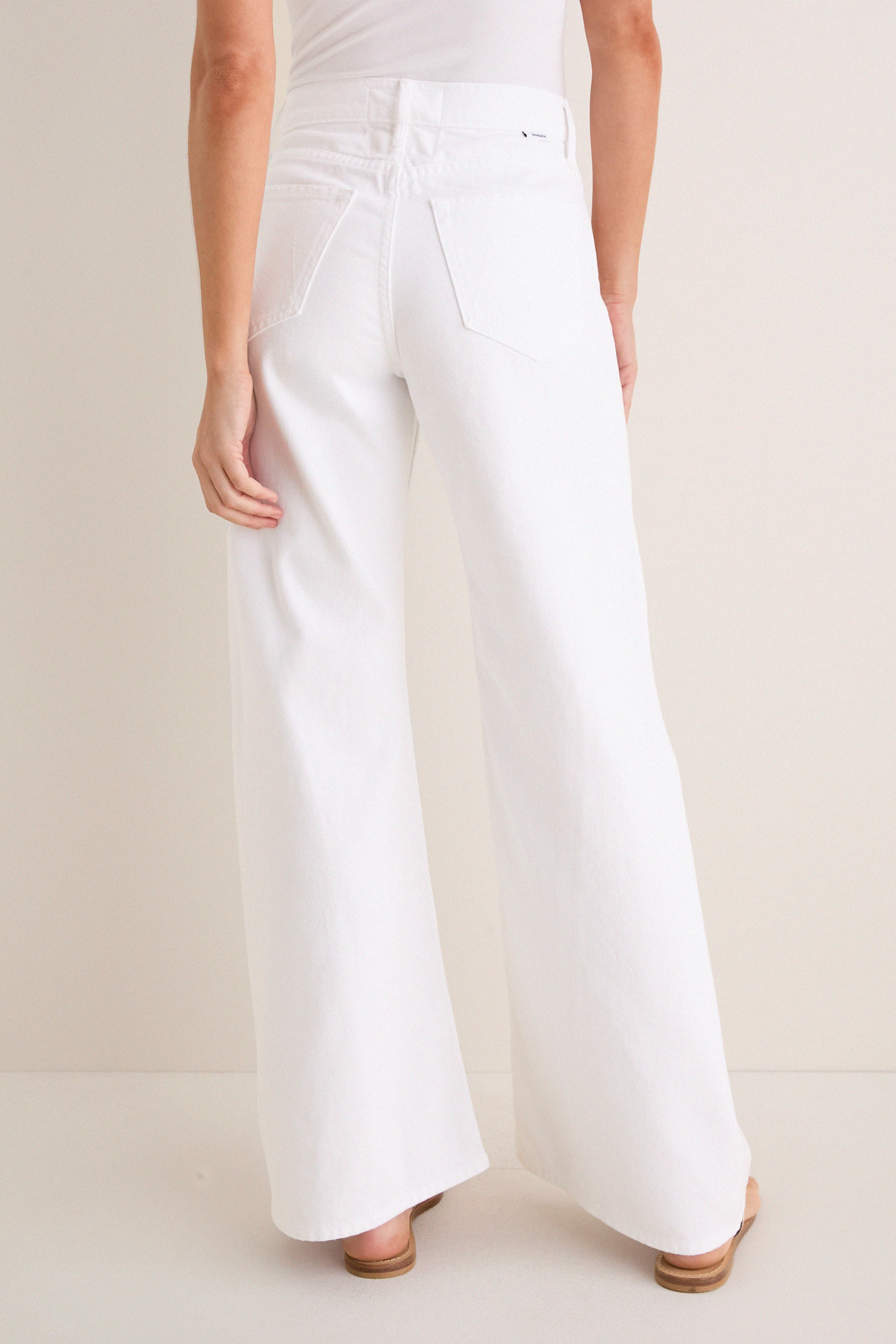 Back view of Pinch of Salt The Lemon Twist Skimp, featuring high-waisted, wide-leg white pants with rear pockets, embodying a classic, effortless style with high-end appeal.