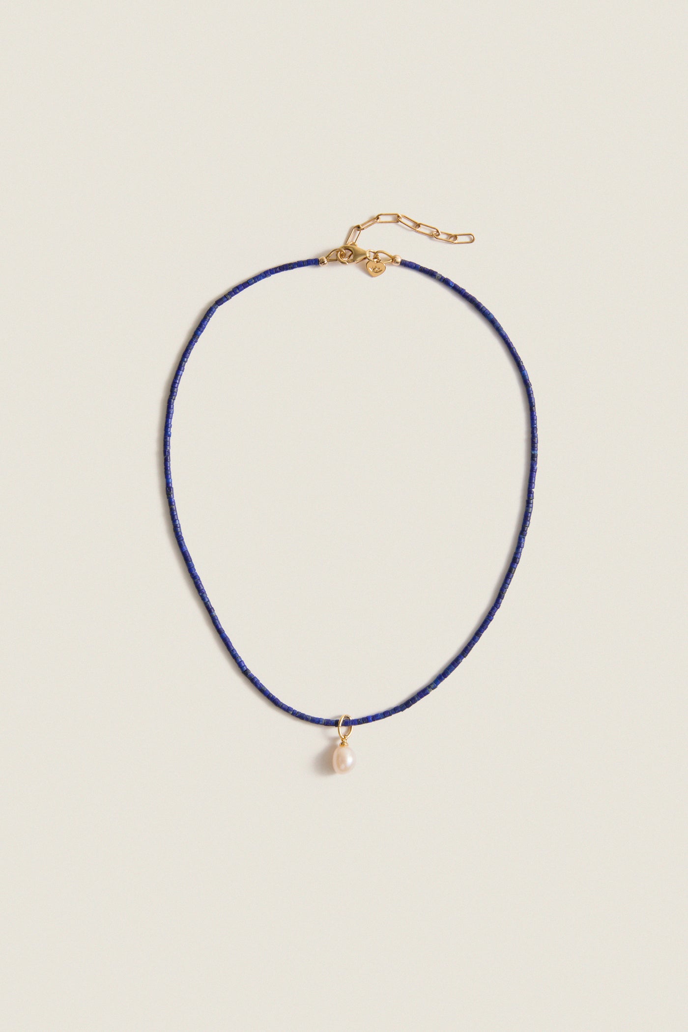 Lapis Lazuli Teeny Gemstone Necklace with Cloud Pearl Charm, featuring a classic, effortless design with high-end detailing, including an adjustable clasp and a fun, removable pearl pendant.