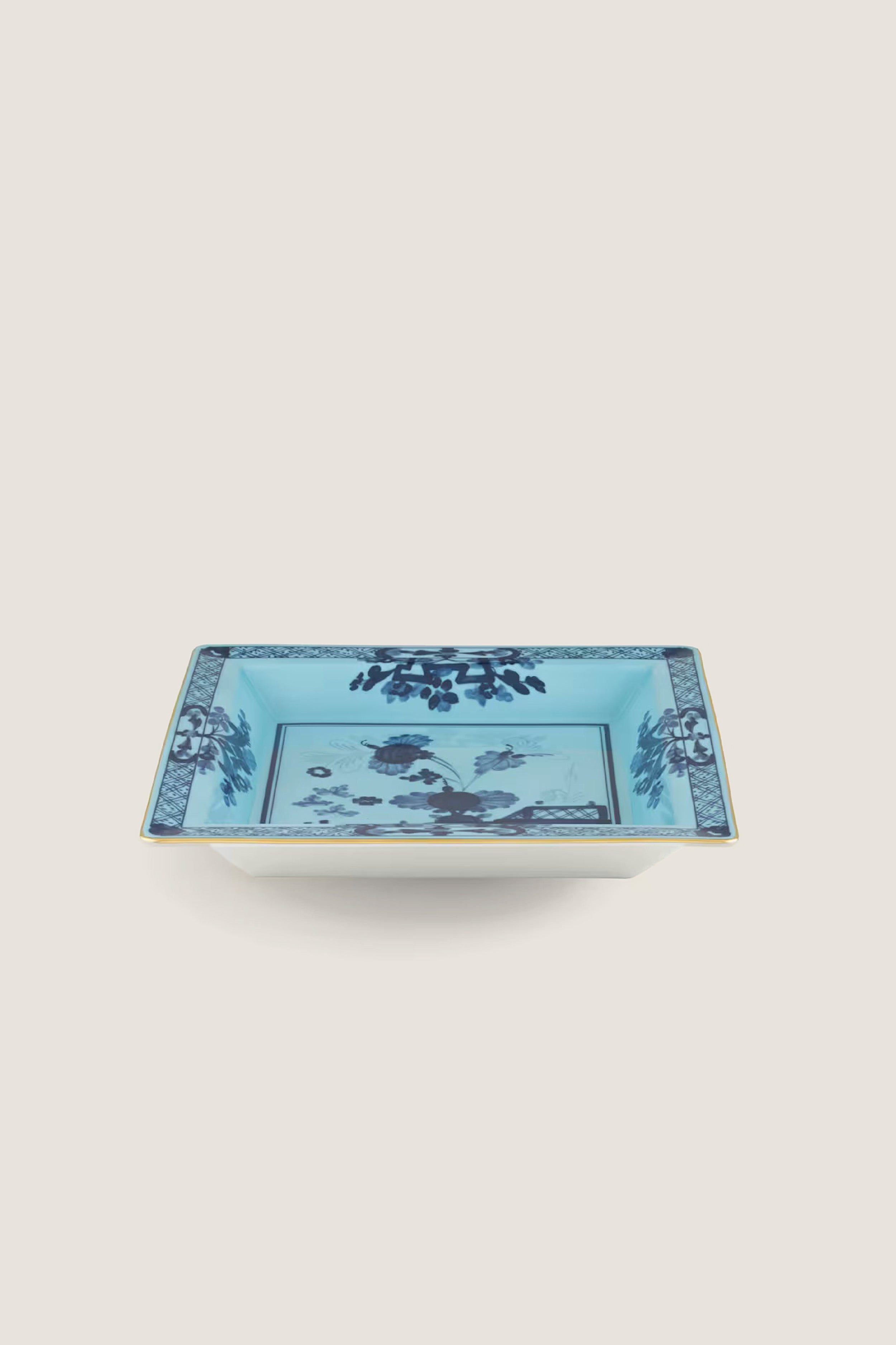 Oriente Italiano Iris Large Square Change Tray: A classic porcelain dish with blue floral motifs, gold trim, effortlessly blending fun and high-end style. Perfect for a chic, confident space.