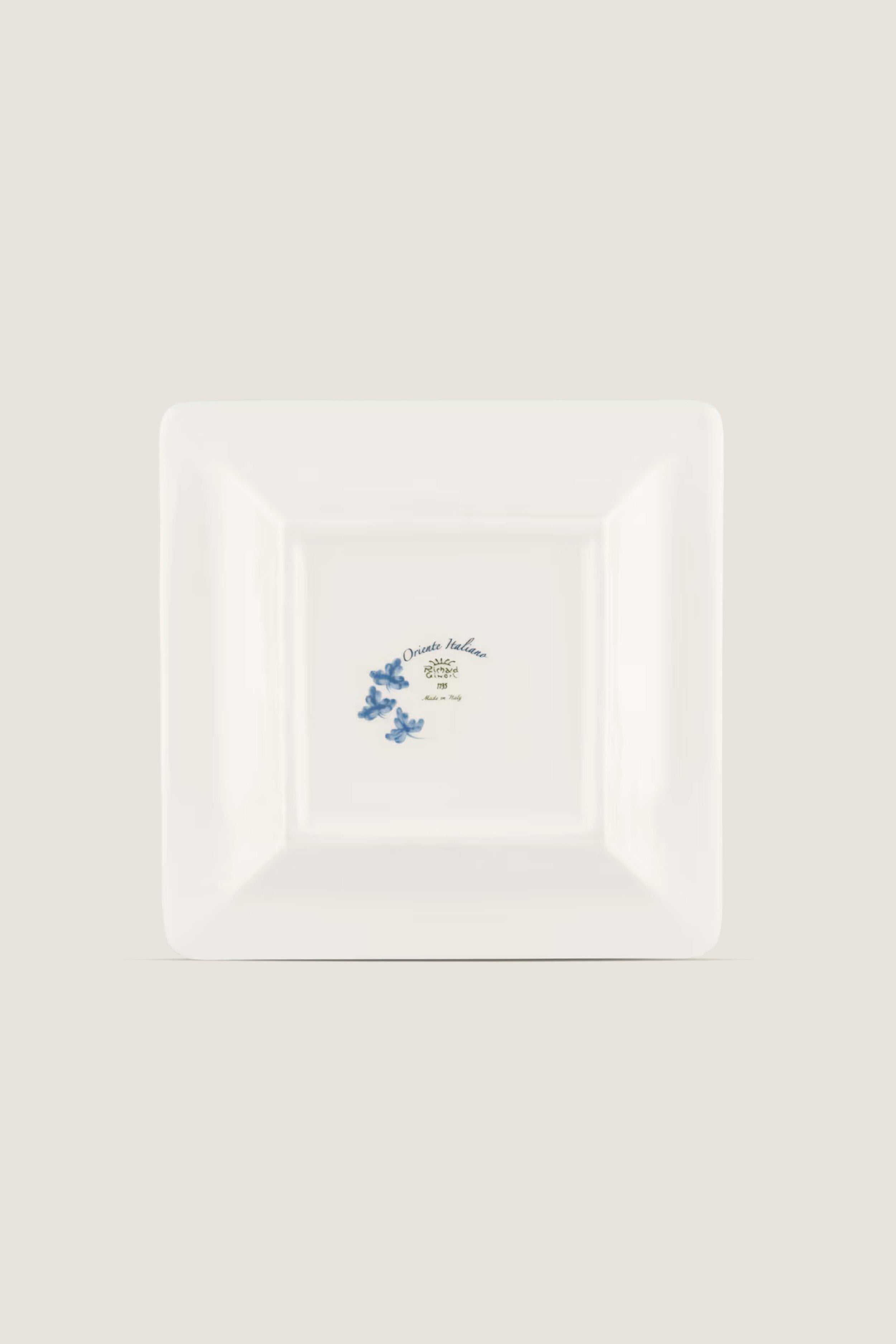 Oriente Italiano Iris Large Square Change Tray: A classic porcelain plate with blue floral motifs and gold trim, offering effortless elegance and high-end artistic craftsmanship.