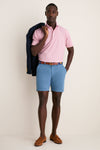 Man in classic Storm Andrews Flat-Front Shorts, showcasing effortless, high-end style with a navy blazer and brown loafers, epitomizing fun, confident seasonal fashion.