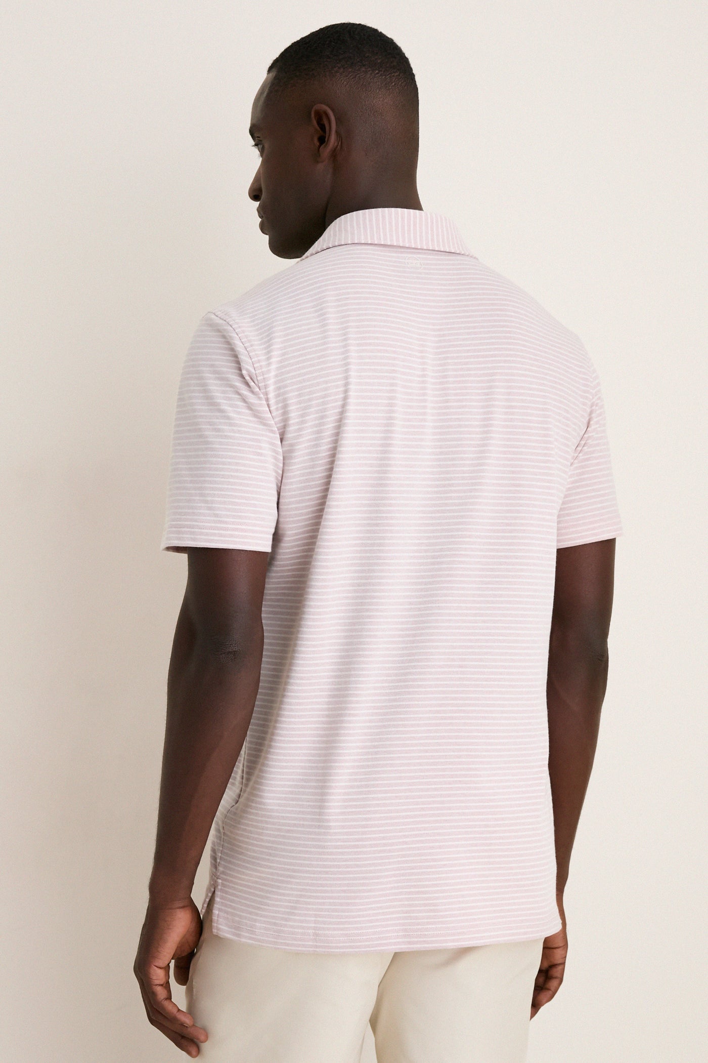 Back view of a man wearing the Faded Scarlet Stripe Albatross Cotton Blend Pique Polo, showcasing its classic design and effortless elegance with a high-end finish.