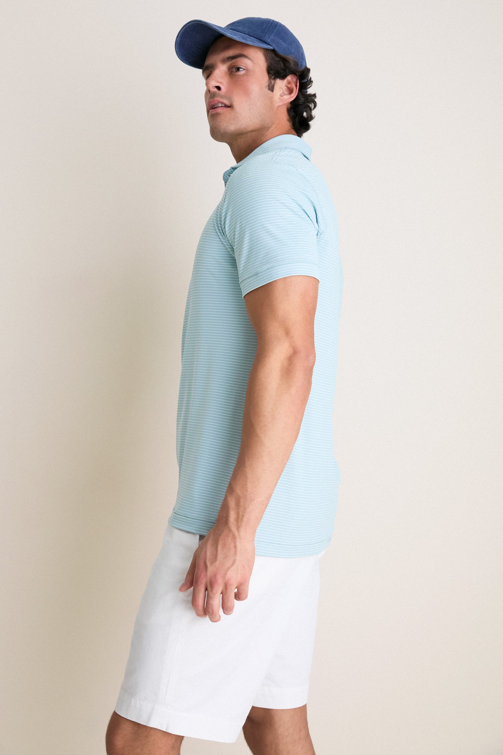 Young man models the classic Light Willow Ballad Performance Jersey Polo, showcasing its effortless, high-end style and technical features, perfect for a fun, casual look.