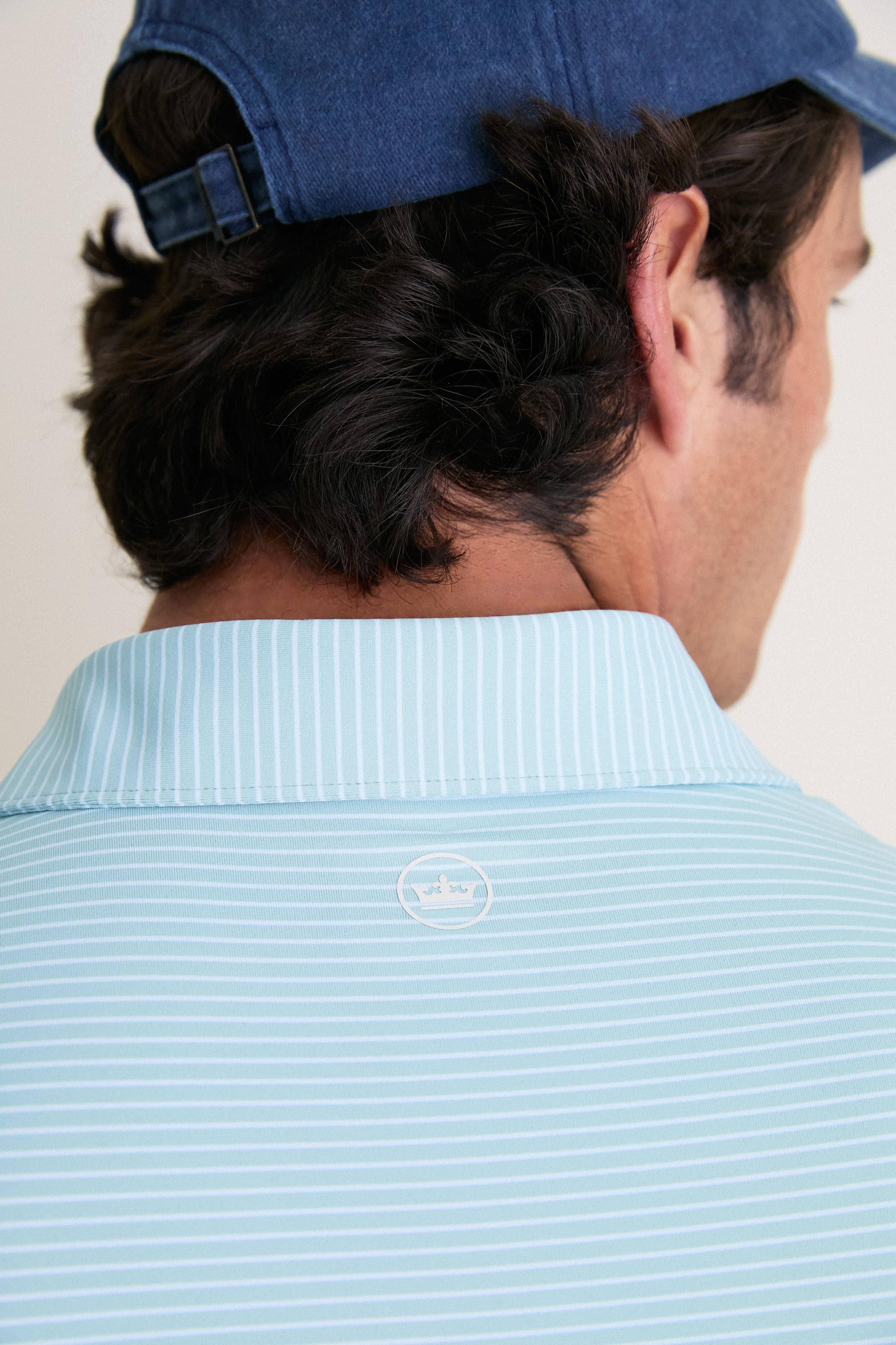 Back view of a man wearing the Light Willow Ballad Performance Jersey Polo, showcasing its classic, effortless style with a tailored fit and high-end craftsmanship.