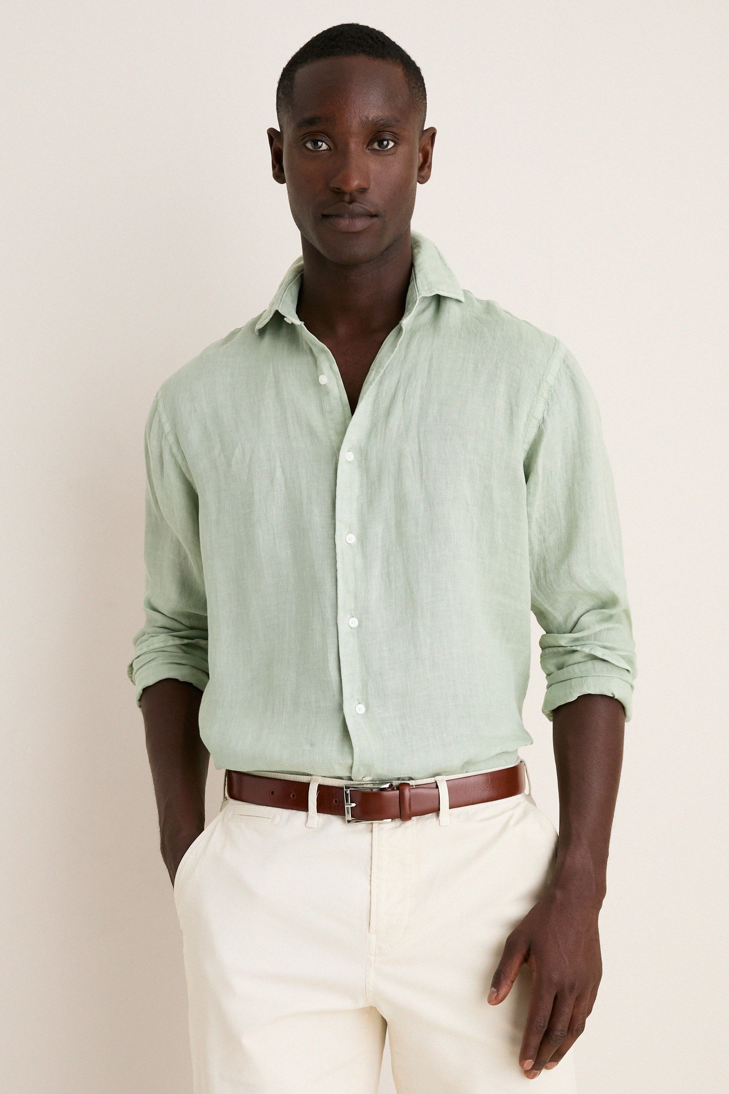 Young Black man models the Grandview Shoreside Linen Sports Shirt, a classic, effortless, high-end button-down, perfect for a fun, confident, and versatile wardrobe.