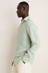 Side-profile of a man in a classic, high-end Grandview Shoreside Linen Sports Shirt, showcasing effortless style with its button-down detail and lightweight, easy-care fabric.