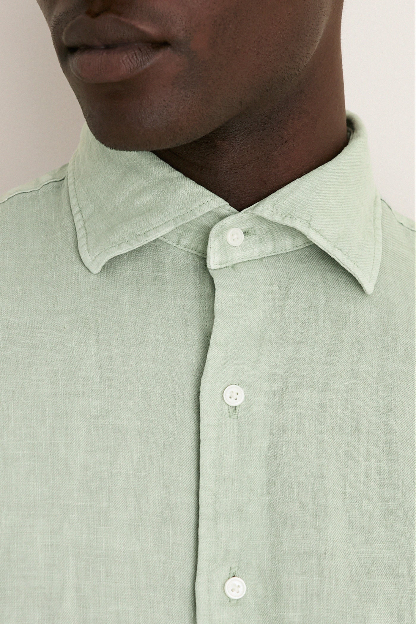 Close-up of a person wearing the Grandview Shoreside Linen Sports Shirt, a classic, effortless high-end button-down with a button-down collar, perfect for a fun, confident look.