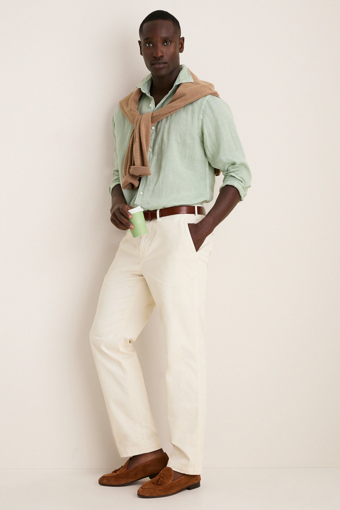 Man wearing the Grandview Shoreside Linen Sports Shirt, effortlessly styled with chinos and loafers, embodies Tuckernuck's classic and high-end fashion for a fun, confident look.