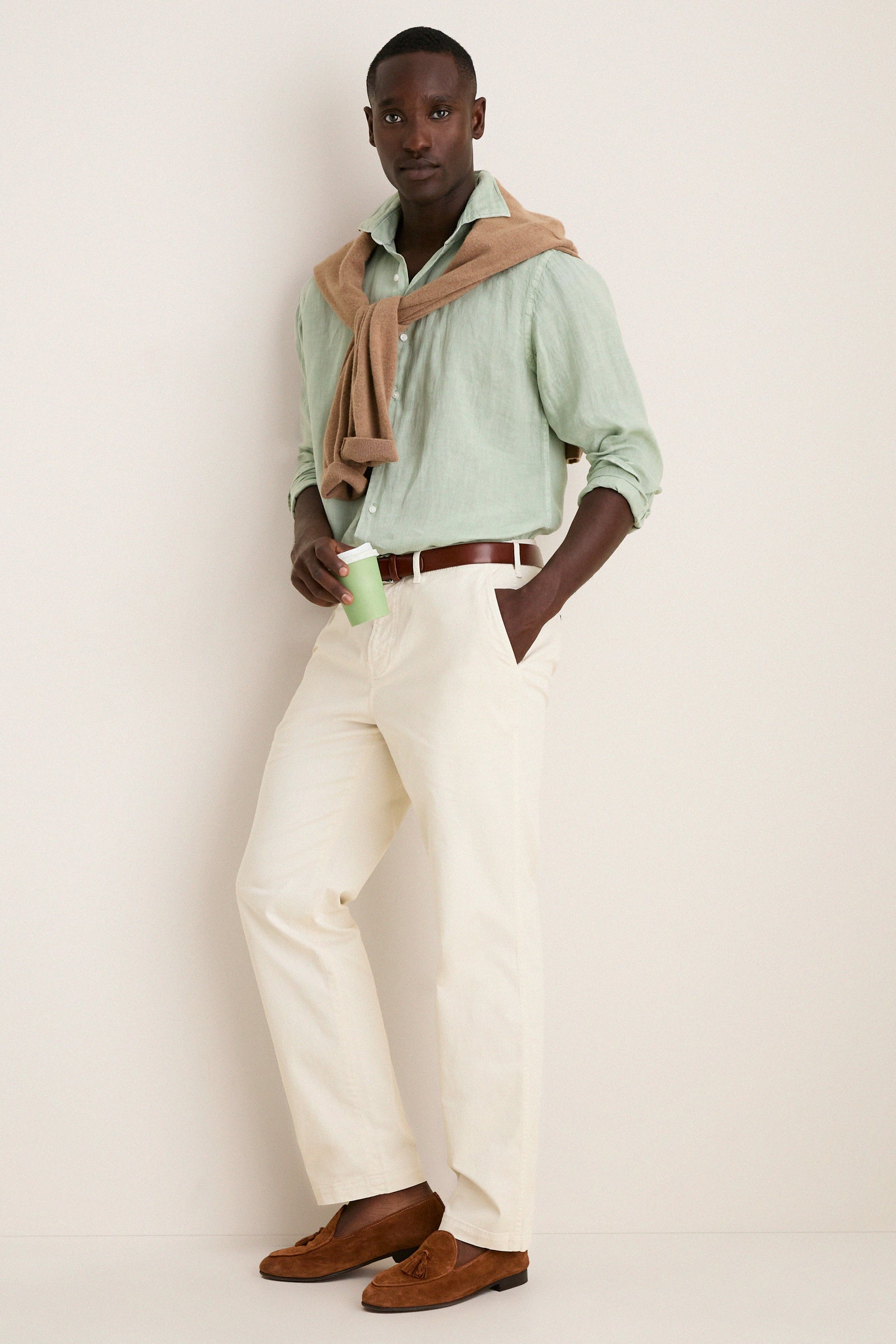 Man wearing the Grandview Shoreside Linen Sports Shirt, effortlessly styled with chinos and loafers, embodies Tuckernuck's classic and high-end fashion for a fun, confident look.