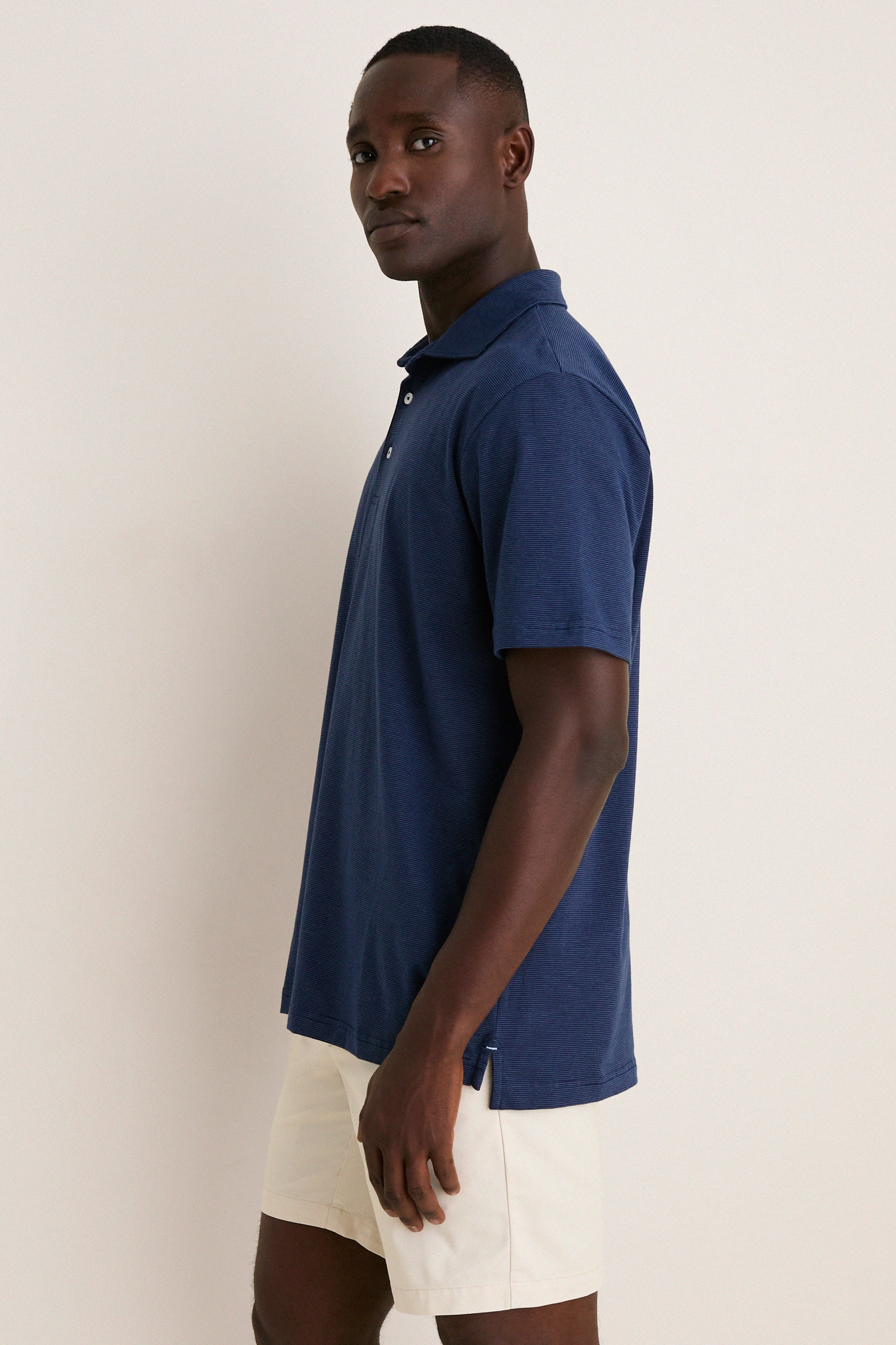 Navy Ryles Crown Flex Cotton Polo on a young man captures a classic, effortless style. This high-end, fun polo features a cutaway collar and streamlined fit.