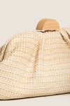 The Natural Dorothea Clutch, a classic woven handbag with a wooden half-moon clasp, exudes effortless style. This fun, high-end accessory is perfect for versatile, chic outings.