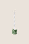 Cruciferous Leaf Taper Candleholder: A classic, effortless white candle with a bubble form in a high-end, intricate leaf-patterned stoneware base, adding fun elegance to any setting.