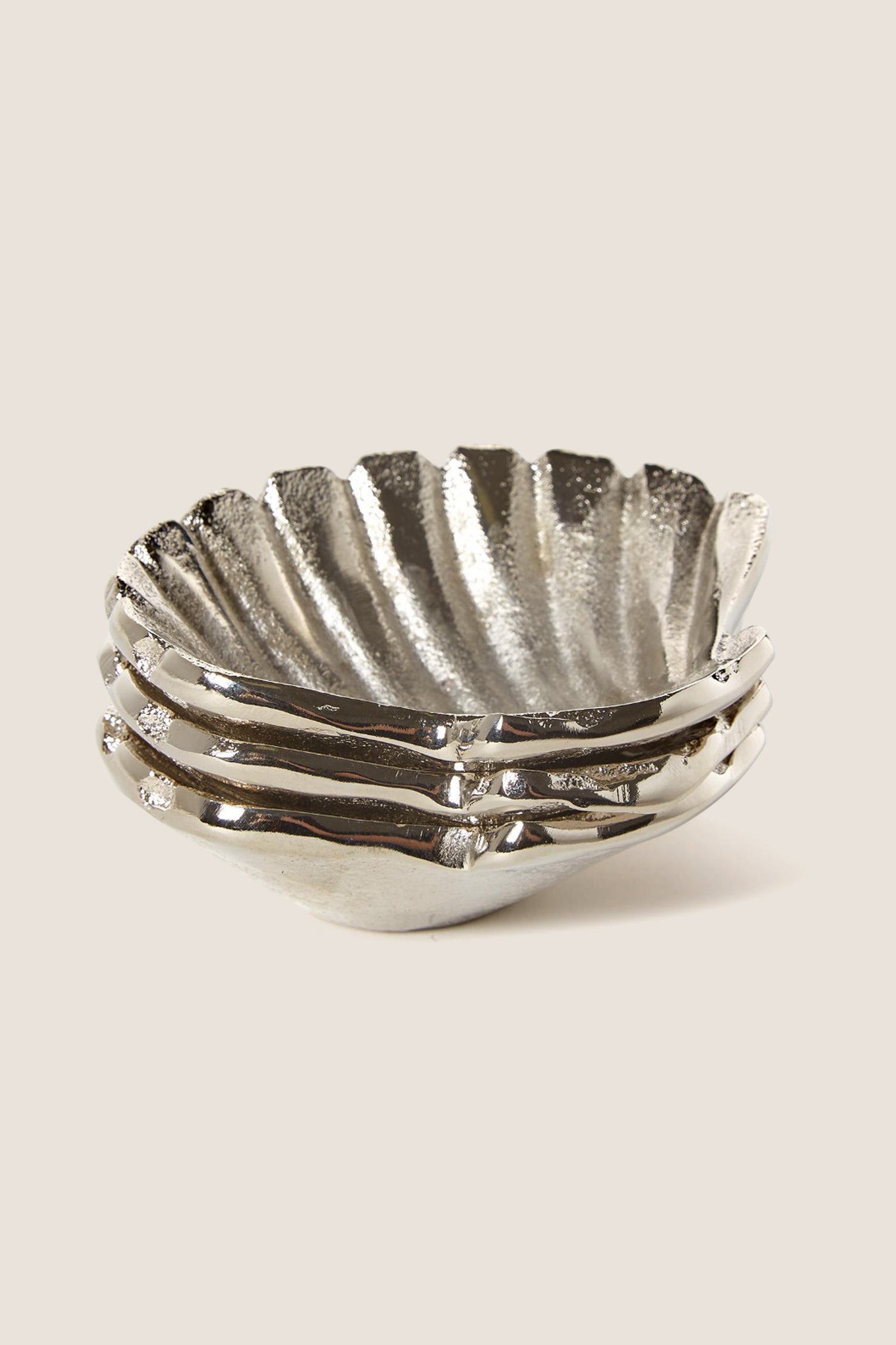 Silver Clam Shell Tidbit Dishes (Set of 3) feature classic, scalloped-edge design; effortlessly fun and high-end for serving appetizers, aligning with Tuckernuck's cool, confident style.