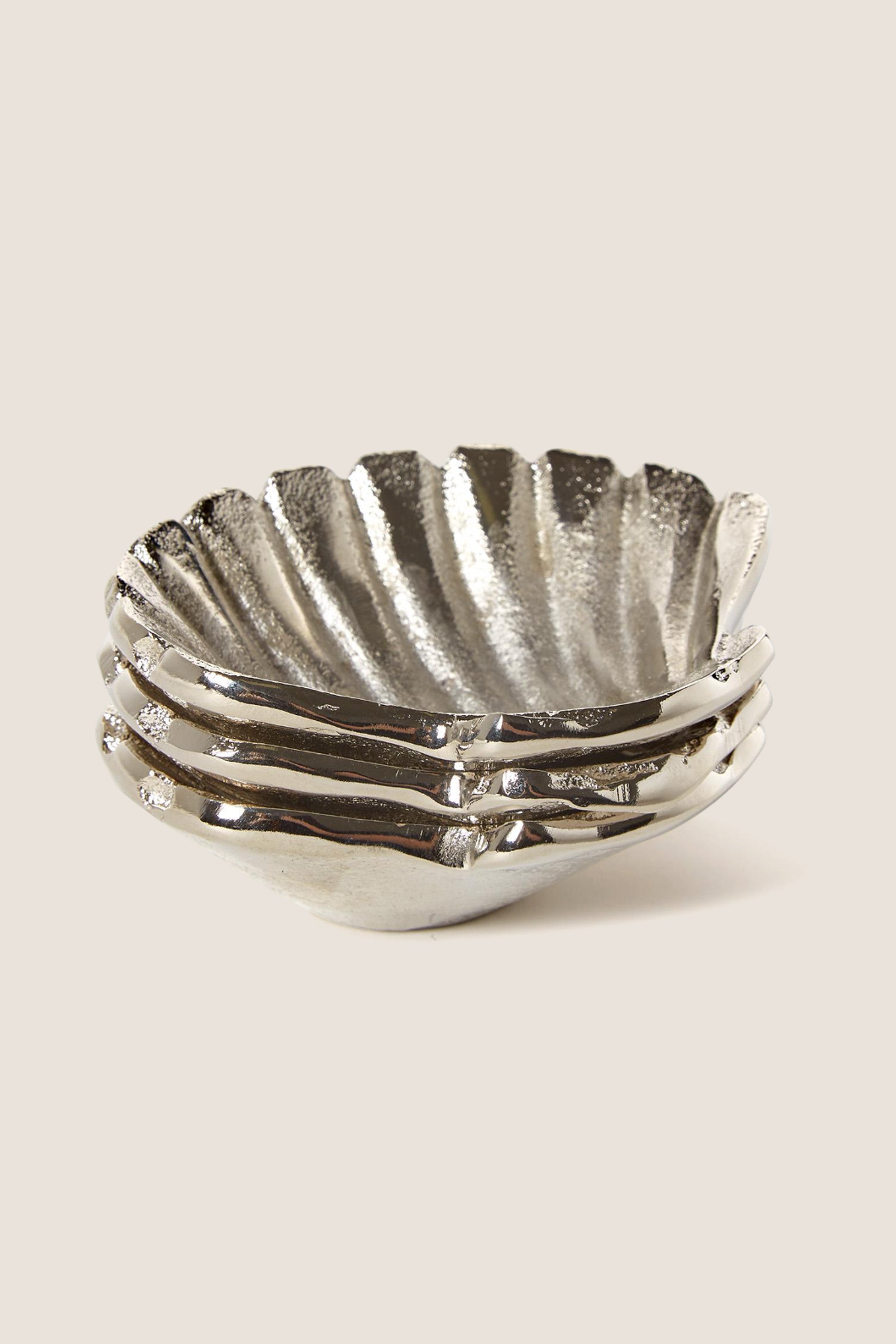 Silver Clam Shell Tidbit Dishes (Set of 3) feature classic, scalloped-edge design; effortlessly fun and high-end for serving appetizers, aligning with Tuckernuck's cool, confident style.