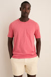 Young man wearing the Coral Red Sunwashed Pocket Tee, showcasing its classic, effortless style with a relaxed fit and fun, high-end design.
