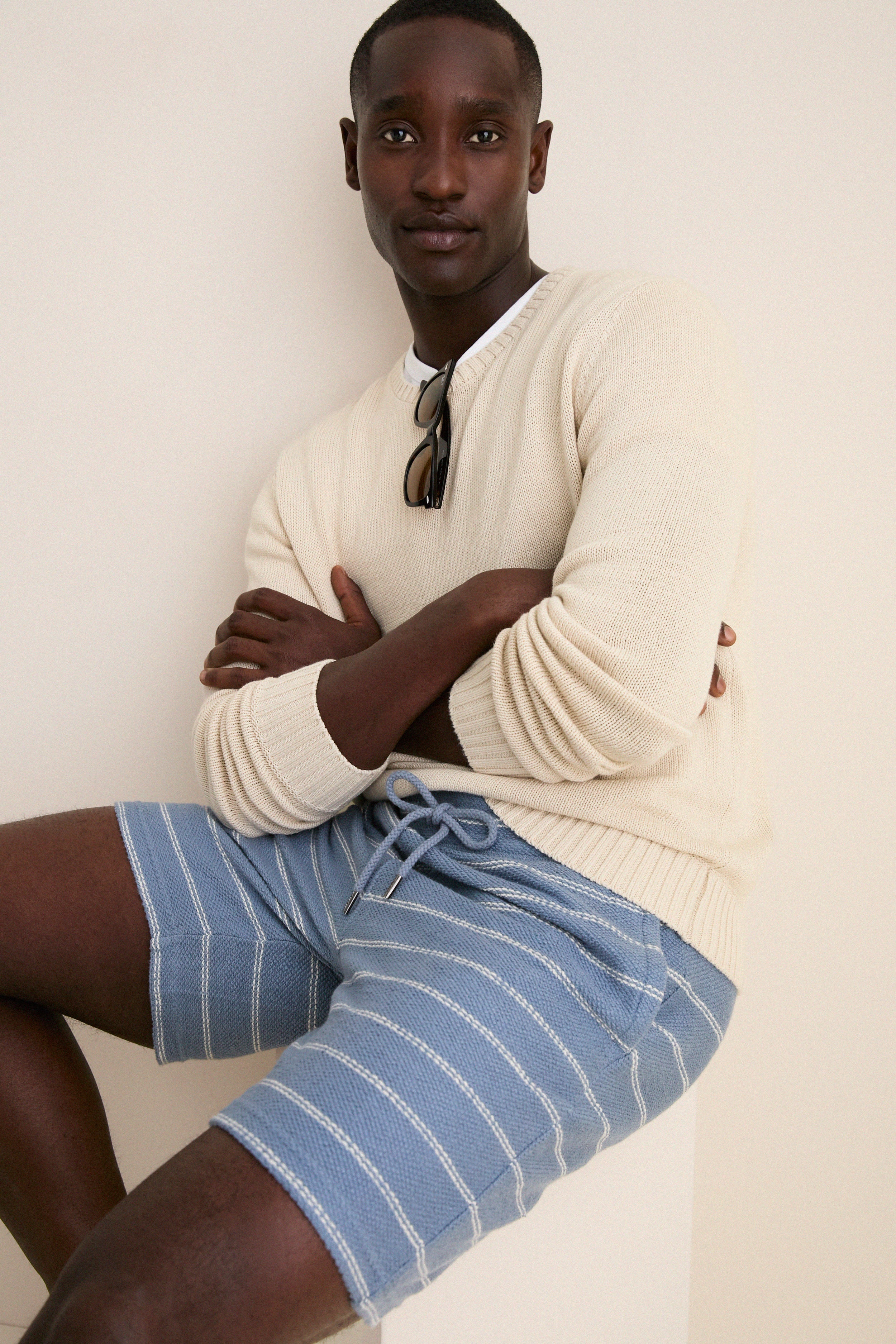 Male model wearing Seabrook Stripe Whitewater Shorts; classic and effortless style with jacquard stripes, elastic waist, embodying high-end, fun, and laid-back summer fashion.