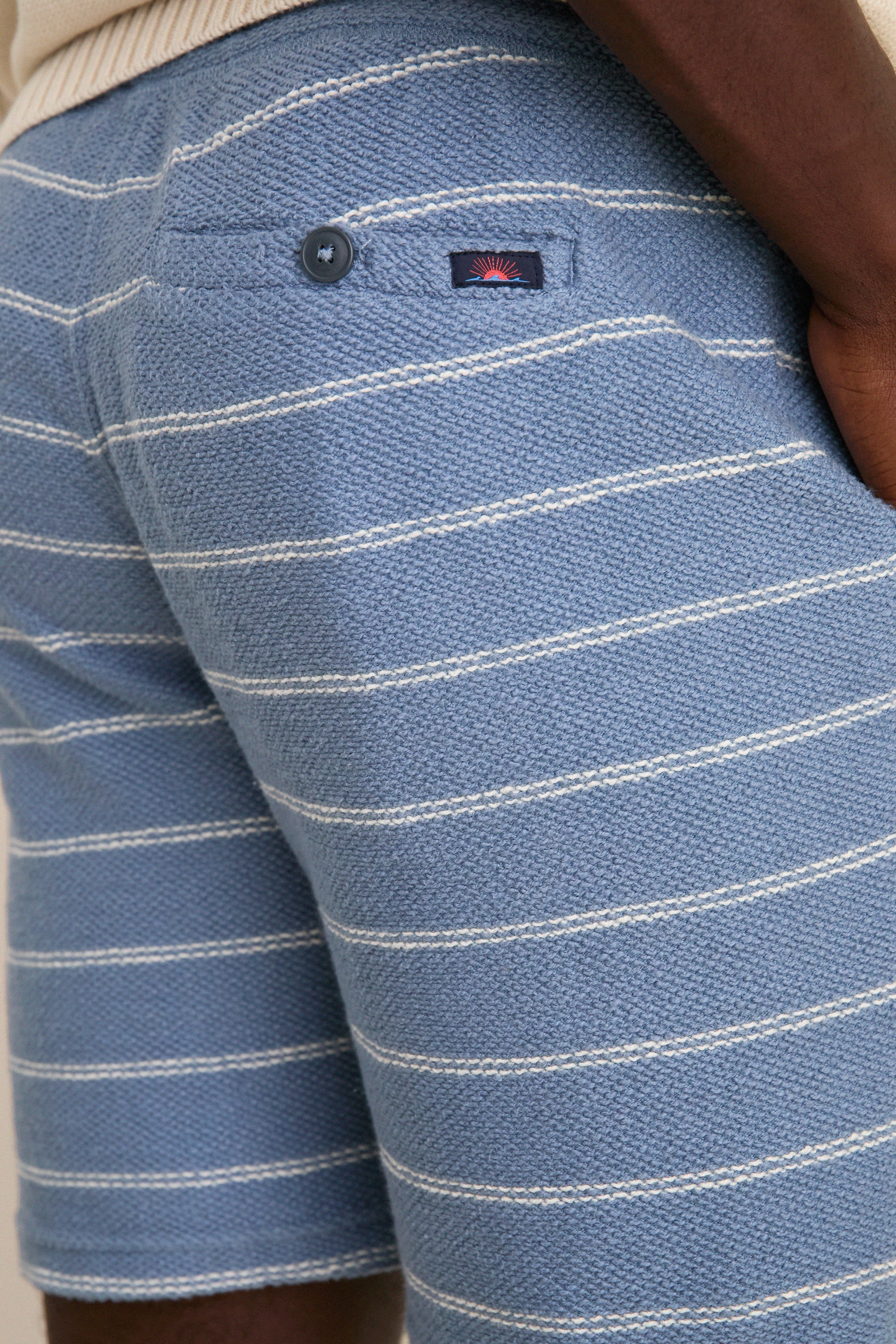 Seabrook Stripe Whitewater Shorts with classic white stripes, button-flap back pocket, and logo patch, offer an effortless, high-end look for fun, laid-back days.