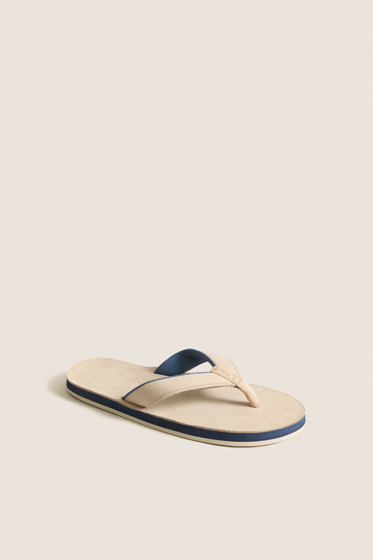 Sand Pier Pebbled Leather Sandal with a classic, minimalist design; features a light beige footbed and stylish Y-shaped strap, perfect for effortless, high-end casual wear.