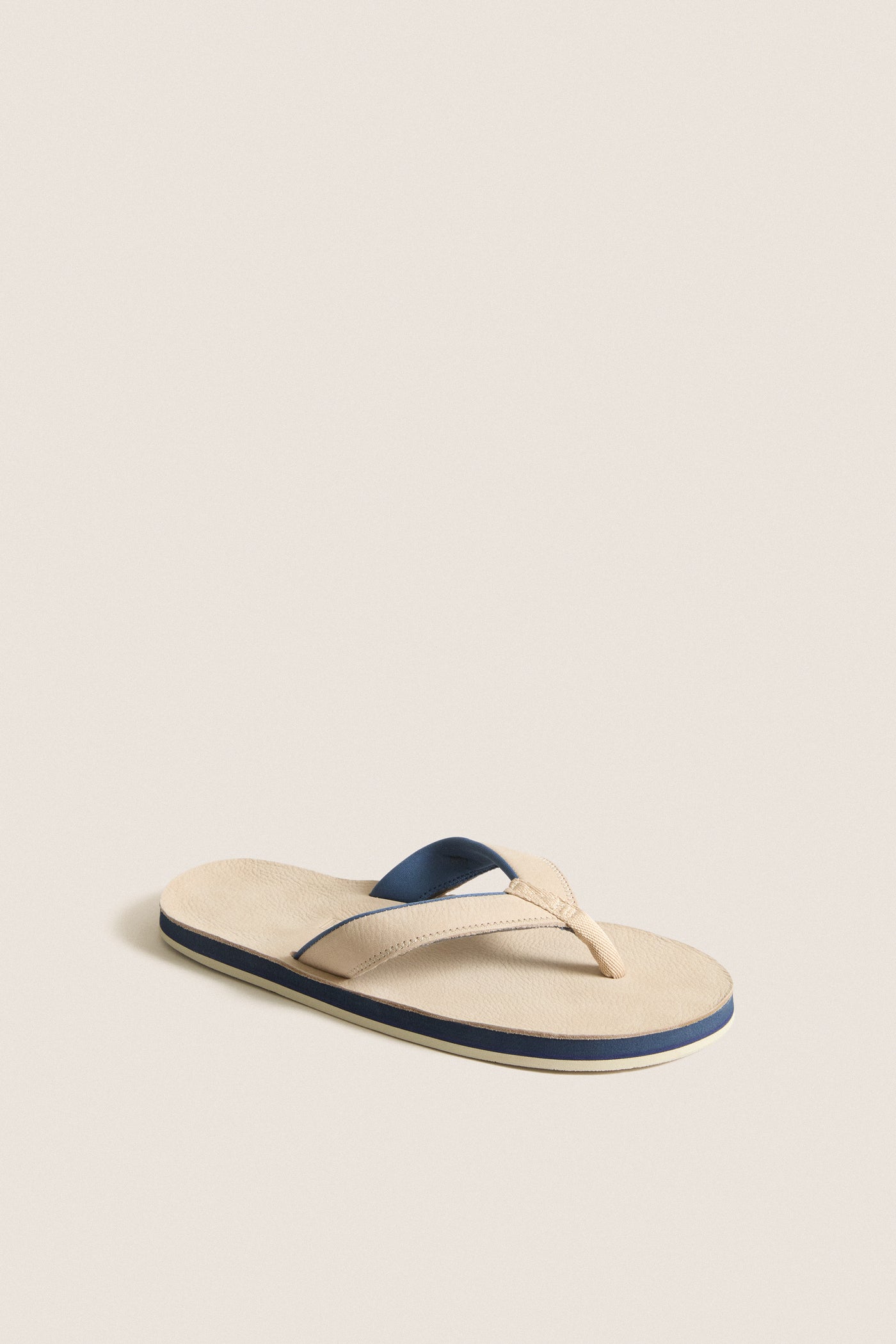 Sand Pier Pebbled Leather Sandal with a classic, minimalist design; features a light beige footbed and stylish Y-shaped strap, perfect for effortless, high-end casual wear.