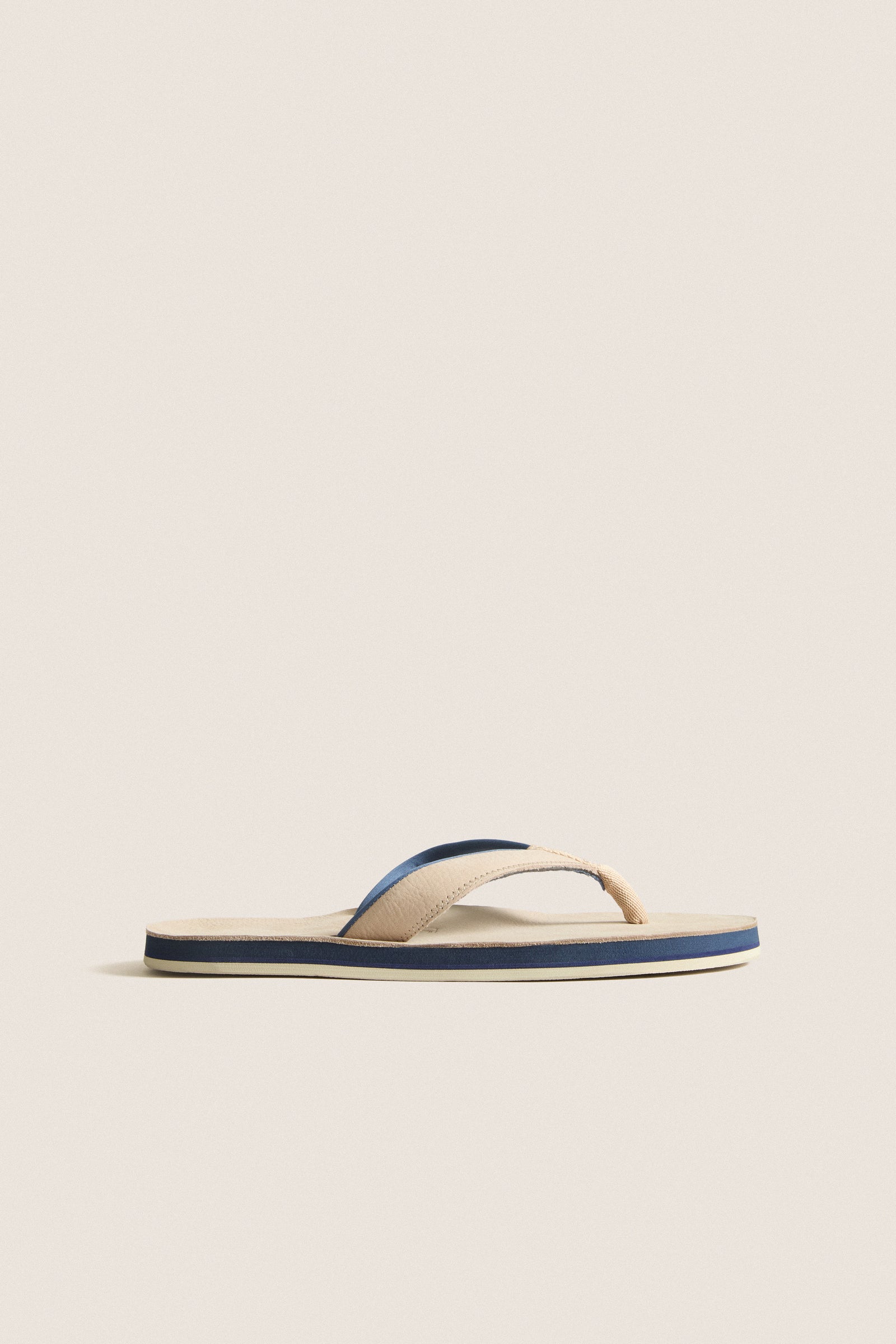 Classic Sand Pier Pebbled Leather Sandal with beige straps, navy and cream striped sole, offering effortless style and high-end comfort for fun, relaxed outings.