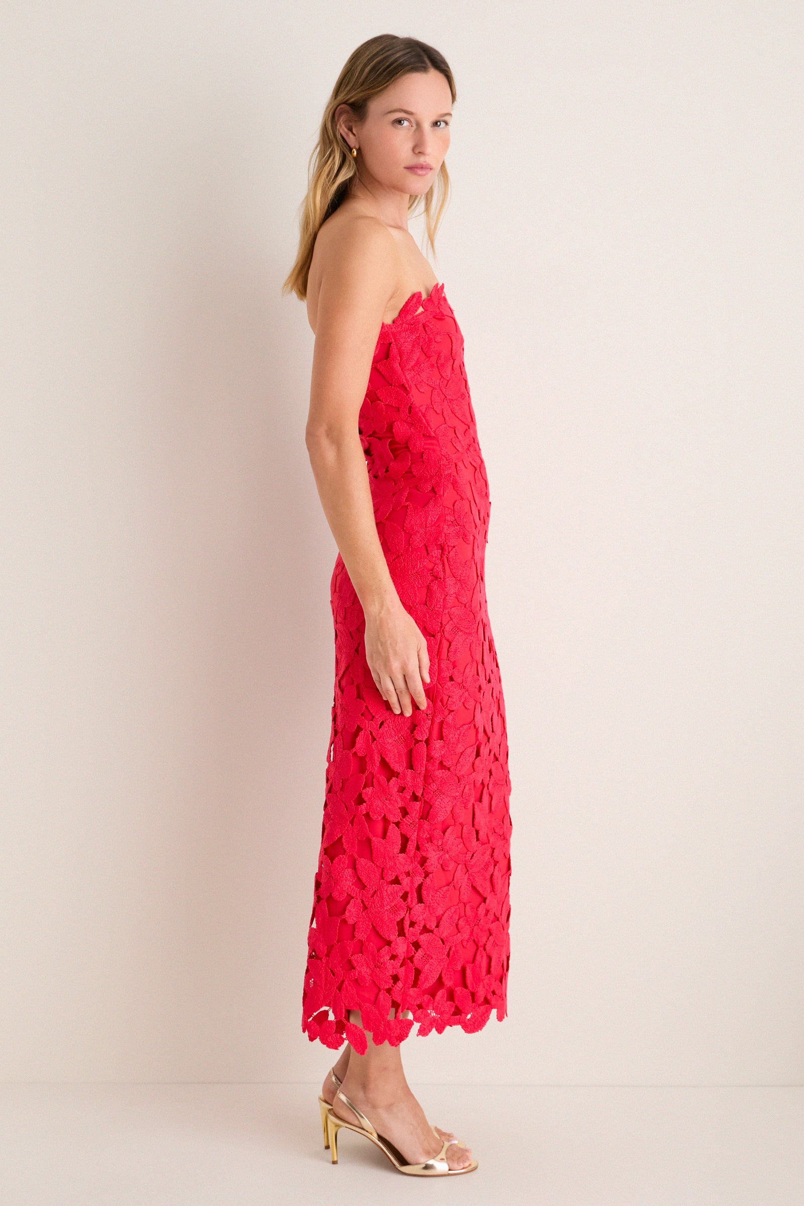 Classic and effortless, the Cherry Red Philomena Midi Dress in floral lace exudes high-end fun, paired with metallic gold sandals and hoop earrings.