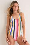 Pariti Fiesta Retiro One Piece showcases bold vertical stripes, offering a classic and effortless style, complemented by a simple gold necklace and hoop earrings for a fun, high-end look.