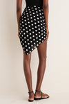 Person in black polka dot skirt exuding effortless style with Polka Dot Noir Bandana as chic pareo, embodying classic high-end charm.