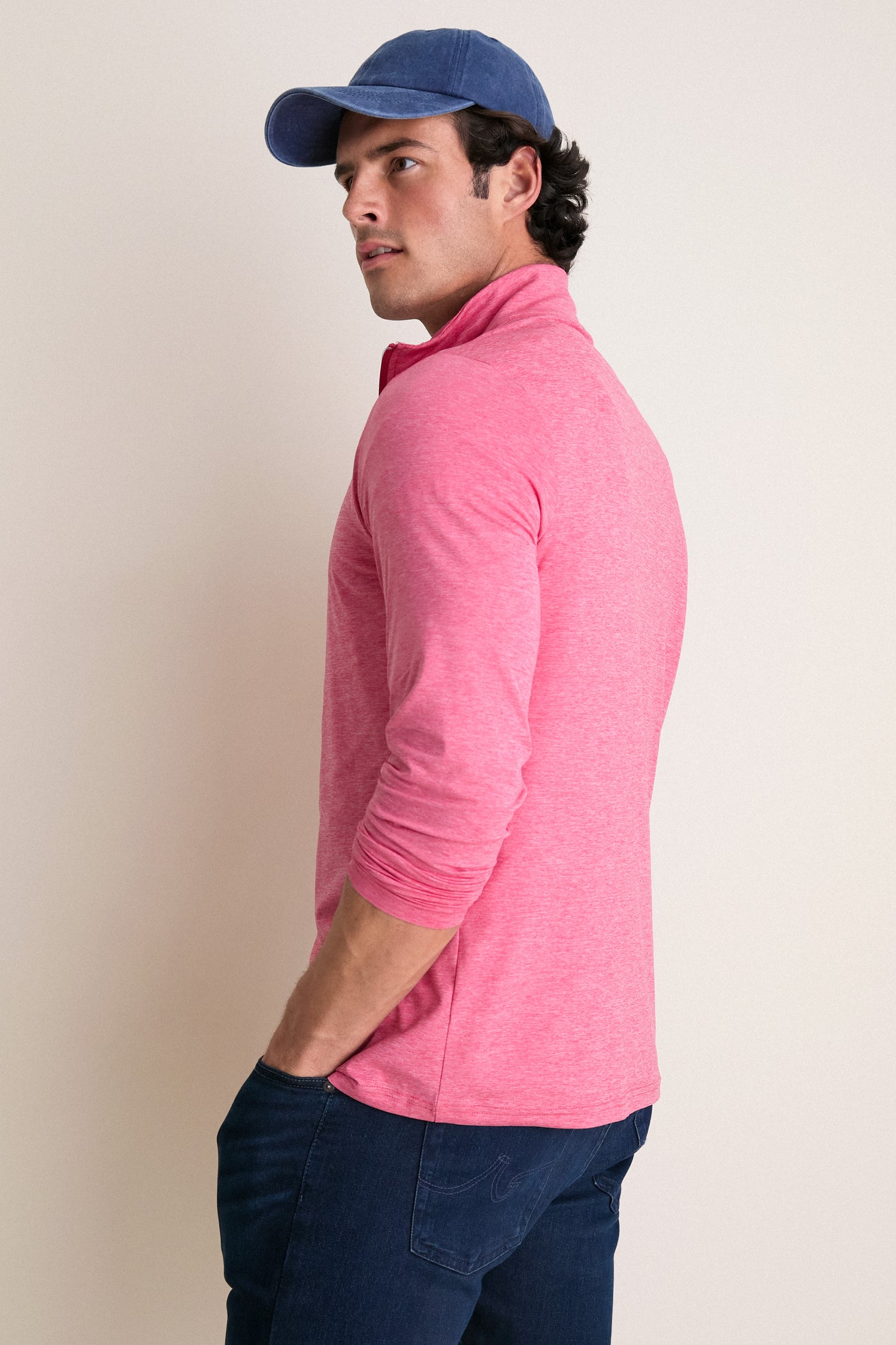 Man in profile wearing Heathered Red Featherweight Performance Pullover, showcasing its classic and effortless style. Perfect for both high-end activities and fun adventures.