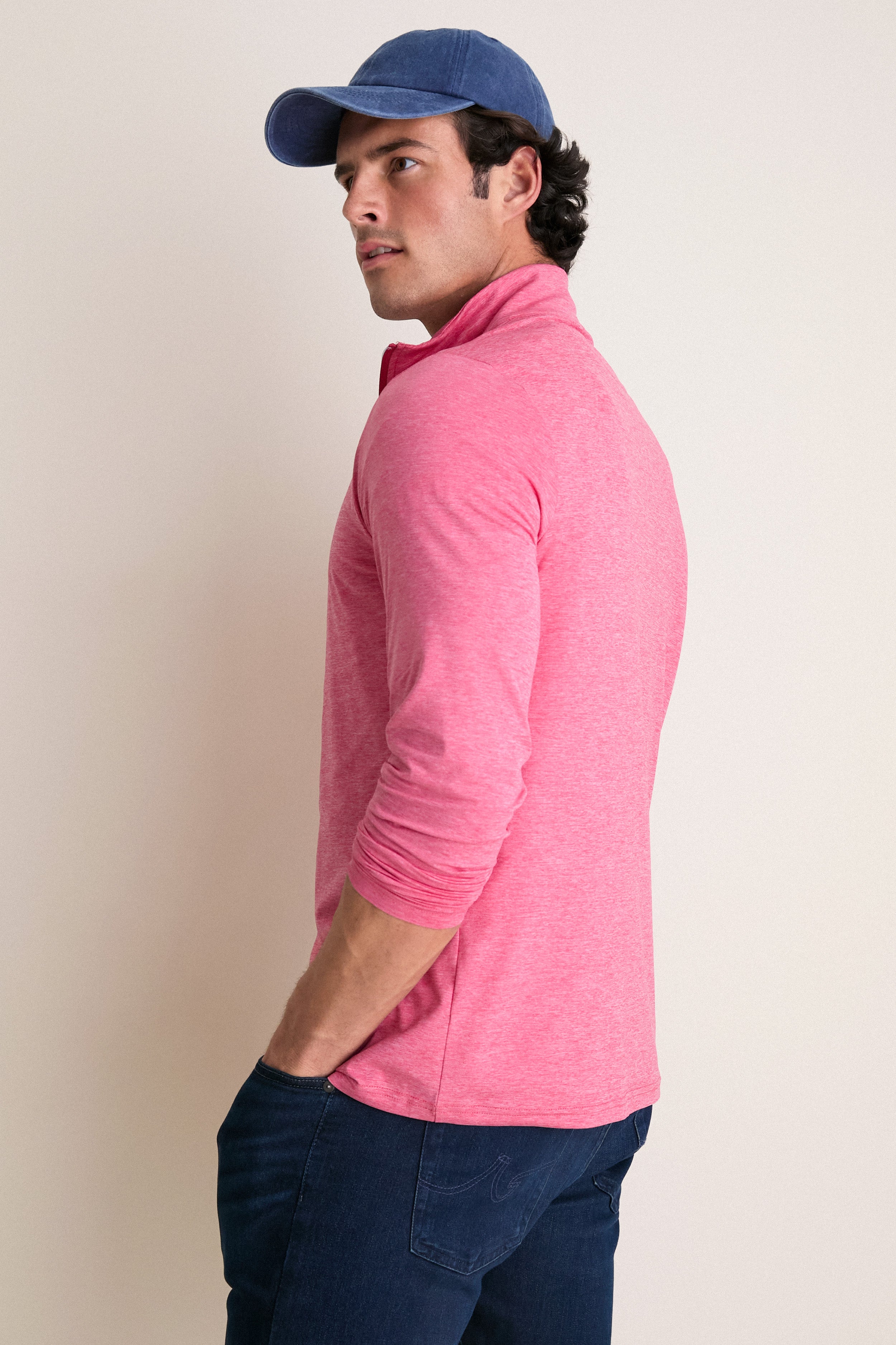 Man in profile wearing Heathered Red Featherweight Performance Pullover, showcasing its classic and effortless style. Perfect for both high-end activities and fun adventures.