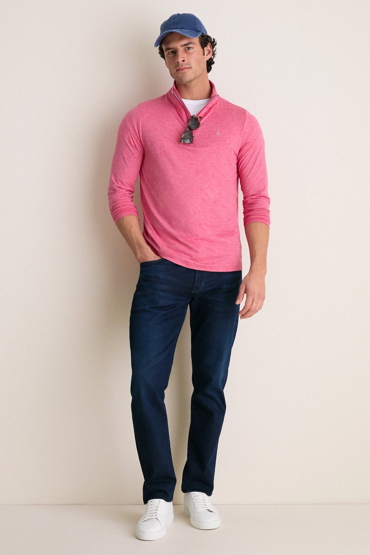 Young man models classic Heathered Red Featherweight Performance Pullover; features effortless style, stand collar, and sunglasses, embodying Tuckernuck's fun, high-end lifestyle.