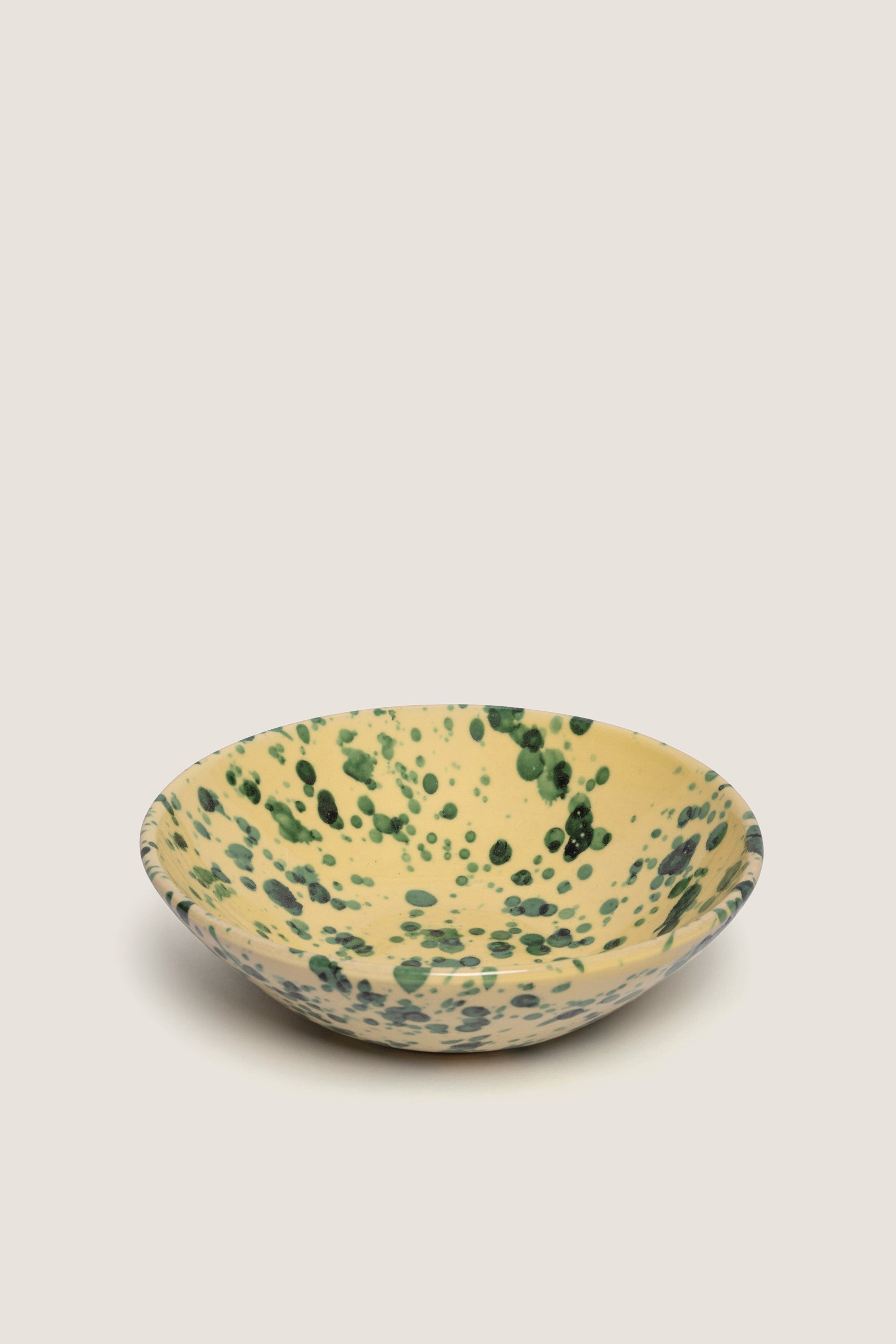 Yellow and Verde Large Splatter Bowl: A classic, high-end ceramic bowl with effortless splatter design, perfect for serving fun salads or pasta on any occasion.