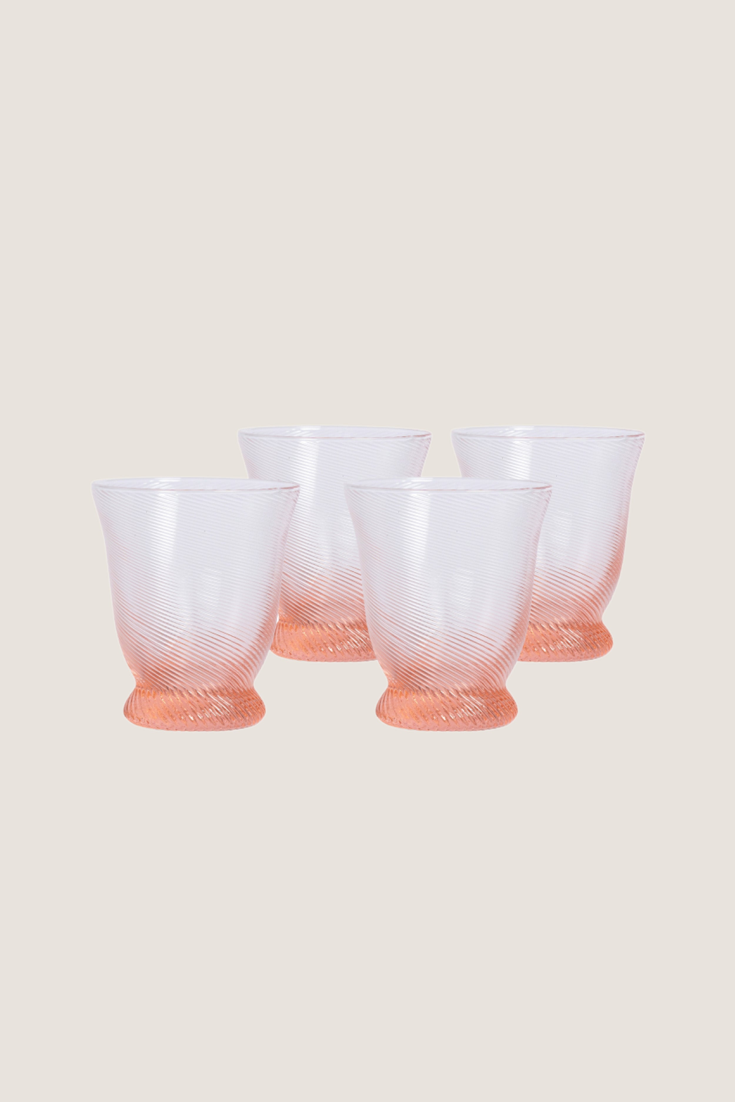 Peony Pink Spiral Tumbler (Set of 4), featuring classic rib-patterned, swirled texture with a flared silhouette, offers an effortless, high-end touch to any fun tablescape.