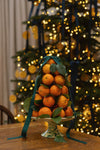 Classic festive display on a high-end Yellow and Verde Splatter Cake Stand, featuring oranges, leaves, and berries, embodying effortless elegance and fun. Crafted in Italy, dishwasher safe.