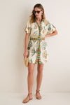 Woman models a classic summer look with Gold Waverly Earrings, an effortless shirt-dress, and fun accessories, showcasing Tuckernuck's high-end style.