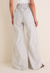 Juniper Stripe Linen Tulip Wide Leg Pant showcasing classic, effortless style with a relaxed, high-end silhouette; features a cinched waist and flared legs for fun, warm-weather wear.